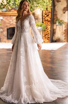 a woman in a white wedding dress posing for the camera