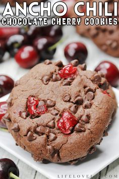 ancho chili chocolate cherry cookies on a white plate with cherries in the background