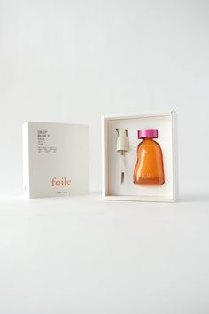 an orange bottle in a white box next to a gold and pink object that says folite