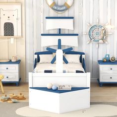 a bedroom with blue and white furniture in the corner, along with a clock on the wall