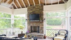 an outdoor living room with couches, chairs and a television on the fireplace in it