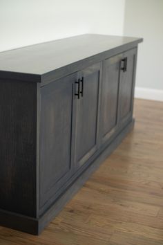 a large wooden cabinet sitting on top of a hard wood floor