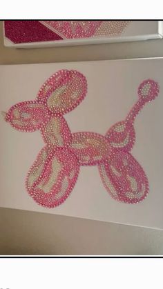 the pink dog is made out of beads