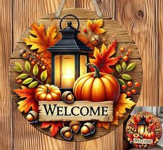 a welcome sign hanging from the side of a wooden fence with autumn leaves and pumpkins