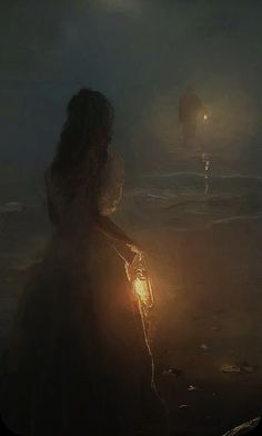 a woman standing in the water holding a lantern