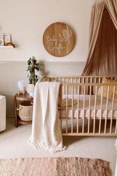 a baby's room with a crib, rocking chair and wall hangings