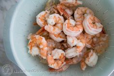 a bowl filled with shrimp on top of a table