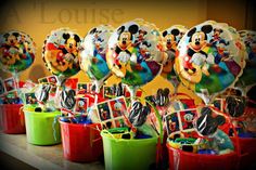 many mickey mouse balloons are on display in buckets