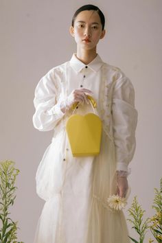 Material: Genuine leather Color: Yellow   This light yellow daisy purse is perfect for any outfit. The zip closure and detachable strap makes it easy to use as a clutch or shoulder bag. It's also adjustable so you can wear it at the length that best fits your needs! Spring Evening Bucket Bag With Top Handle, Spring Shoulder Bag With Detachable Pouch, Spring Shoulder Bag With Removable Pouch, Spring Evening Rectangular Bucket Bag, Yellow Shoulder Bag With Adjustable Strap For Spring, Spring Yellow Shoulder Bag With Adjustable Strap, White Clutch Shoulder Bag For Spring, Spring White Clutch Shoulder Bag, Spring Evening Clutch With Detachable Handle