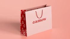 a white shopping bag with the word camow printed on it sitting on a pink background