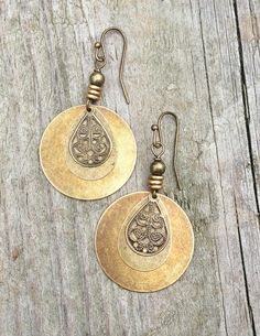 Bohemian style antiqued brass earrings with filigree teardrop and brass accents.Perfect light-weight, medium sized everyday earrings made with layered, antiqued brass. These earrings will add a beautiful rustic, bohemian vibe to any outfit.The largest disc is 1" in diameter which is about the size of quarter.Product overview:- Made with various antiqued brass discs and teardrop- Approximately 1.75" in total hanging length including the ear wire, the largest disc is about the size of a quarter- L Antique Brass Jewelry, Meaningful Gifts For Her, Dangle Earrings Boho, Retro Earring, Cool Gifts For Women, Ethnic Earrings, Bohemian Earrings, Antique Earrings, Beaded Dangle Earrings