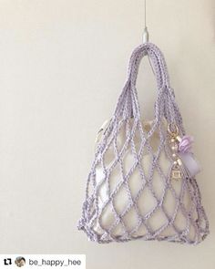 a white purse hanging from a hook on a wall