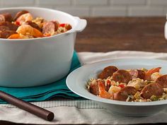 two white bowls filled with food on top of a table