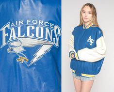 "Vintage 00s jacket in blue with the Air Force Falcons logo on the chest and the back and snaps up the front. Please see measurements and condition below. Every garment we sell is authentic vintage and one-of-a-kind! You will receive the exact item photographed. Condition: Very good vintage. Best fits men's: Labelled Large Tag: Steve And Barry's Material:  Polyester and vinyl MEASUREMENTS Taken from seam to seam while the garment is lying flat. Double the armpit, waist, and hips For reference, m Falcons Logo, Falcon Logo, Mens Fitness, Ncaa, Air Force, Bomber Jacket, Sports Jersey, Jackets & Coats, Street Wear