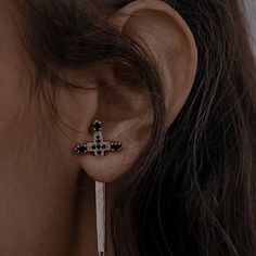 a close up of a person's ear wearing earrings