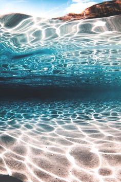 an underwater view of the water and sand