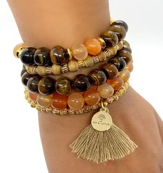 Get wrapped up in this season's hottest trend with this handmade wrap bracelet by OM & Lotus. This crystal bead bracelet wraps around the wrist 5 times creating a great look. Powered by Carnelian and Tigers Eye. Carnelian brings you motivation and stimulates creativity to give you energy to stay amped up for the day. Mixed with Tiger Eye attracting abundance and helps give courage in times of change. Great when you need a boost of energy or when needing to enhance personal power. Product Des Spiritual 8mm Beads Wrap Bracelet For Healing, Adjustable Wrap Bracelet With Gemstones For Meditation, Adjustable Stackable Crystal Bracelet For Meditation, Spiritual Healing Wrap Bracelet With 8mm Beads, Spiritual Gold Wrap Bracelet With Natural Stones, Spiritual Healing Wrap Bracelet, Spiritual Style Wrap Bracelet With 8mm Beads As Gift, Spiritual Wrap Bracelet With Round Beads For Meditation, Spiritual Healing Wrap Bracelet With Round Beads