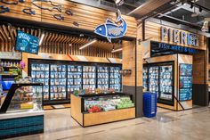 the inside of a grocery store filled with lots of fresh foods and drinks on display