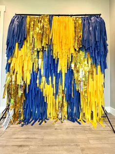 some blue and yellow streamers hanging on a wall