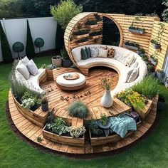 an outdoor seating area in the middle of a yard with lots of plants on it