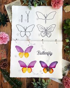 three butterflies are drawn on paper with flowers around them