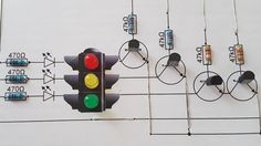 a traffic light with multiple wires attached to it and some lights hanging off the wall