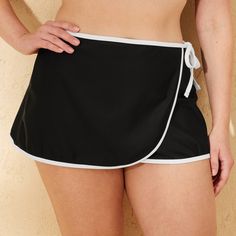 Stay cute and casual by the pool with the Contrast-Binding High-Waist Swim Skirt from Shade & Shore™. Made from nylon tricot fabric with spandex and recycled polyester lining, this high-waist swim skirt comes in black with contrasting white binding for chic look. Featuring a side-tie detail, it includes built-in shorts for medium coverage, offering comfort in and out of the water. Shade & Shore™: Made for the sun & fit for fun. Casual Black Swim Skirt For Pool, Black Short Swim Skirt For Summer, Black Short Length Swim Skirt For Summer, Casual Swim Skirt With Elastic Waistband For Pool, Casual Black Swim Skirt For Poolside, Casual Stretch Skort For Pool, Stretch Casual Skort For Pool, Summer Black Swim Skirt With Built-in Shorts, Beach Skort With Elastic Waistband And Short Inseam