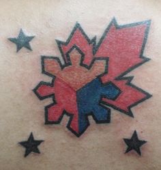 the back of a man's shoulder with stars and a starburst tattoo on it