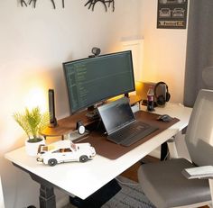 a laptop computer sitting on top of a white desk