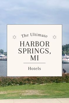 the ultimate harbor springs, mi hotels sign in front of water with boats on it