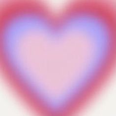 a blurry image of a heart shaped object in pink and blue colors on a white background