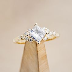 an engagement ring with three princess cut diamonds