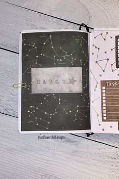 an open planner book with gold stars on it