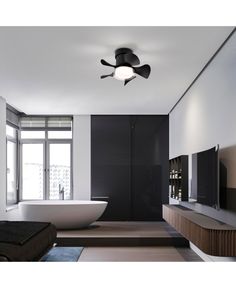 a bathroom with a bathtub, television and ceiling fan