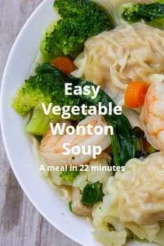 a white plate topped with dumplings and broccoli