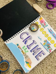 an open notebook with the word crayon on it next to scissors and other crafting supplies