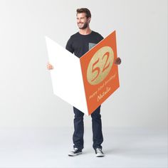 a man holding up a sign with the number fifteen on it's front and side