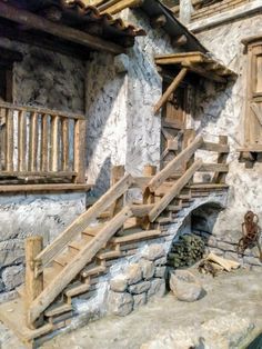 an old stone building with wooden stairs and windows