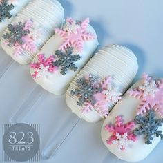 snowflake cake pops with frosting on them are lined up in the shape of christmas trees