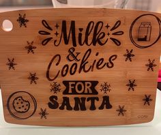 a wooden sign that says milk and cookies for santa