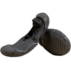 two pairs of black shoes with grey soles on top of each other and one shoe has