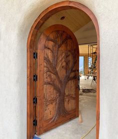 a wooden door with a tree carved into it