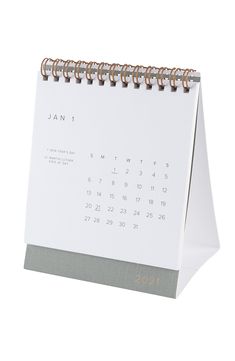 a white and grey calendar sitting on top of a desk