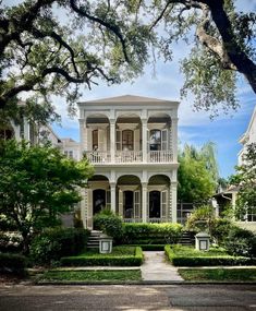 a large white house sitting on the side of a road