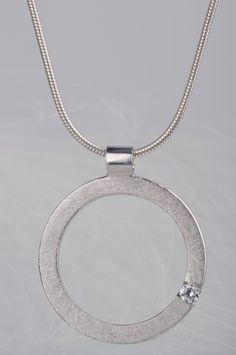 Are you looking for a gift idea for women? How about this minimalist and delicate sterling silver pendant necklace? You can choose which stone you prefer - diamond or zircon. Combination of the brilliant and delicate stone and rough, scratched silver surface makes the necklace look modern, but still subtle and elegant. Since both stones are birthstones (diamond is April birthstone and zircon is December birthstone) this necklace will be a great birthday gift for women. But it would also be a goo Modern Diamond White Pendant Necklaces, Modern Round Solitaire Necklace With Diamond Cut, Modern Diamond White Pendant Necklace, Modern Sterling Silver Necklace With Brilliant Cut, Minimalist Diamond White Necklace With Tension Setting, Modern Round Diamond Necklace With Single Diamond, Modern Necklace With Single Diamond And Round Pendant, Modern Necklace With Single Diamond In Round Pendant, Minimalist Cubic Zirconia Round Pendant Jewelry