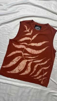 a tank top with red and white designs on it