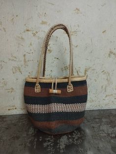 "Baobab bags are handwoven and the material used is from the bark of the Baobab tree that grows wild in Africa. These beautiful baobab baskets are made from Baobab tree bark, the fibers are harvested from the tree (this does not affect the tree, and the fibers grow back) then soaked for the fiber to be soft for weaving, it's then handwoven to make this gorgeous unique patterned bags. This baobab basket can be used as a storage basket,market basket, shopping basket, weekend basket bag, beach bag. Natural Basket Bag Fair Trade, Fair Trade Natural Basket Bag, Natural Basket-shaped Fair Trade Bags, Natural Fair Trade Basket Bag, Fair Trade Basket Crochet Bag For Travel, Everyday Use Brown Handwoven Straw Bag, Fair Trade Crochet Basket Bag For Travel, Brown Weaving Shoulder Bag For Daily Use, Handwoven Jute Bucket Bag