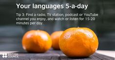 two oranges sitting next to each other on a wooden table with the words your languages 5 - a - day