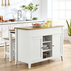 a white kitchen island with wooden top and drawers