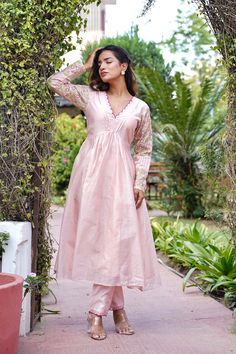 Let your ethnicity take the stage with this Peach Embroidered Chanderi Kurta with Pants Set. This two-piece set includes a kurta with pants. The Peach chanderi kurta has embroidery, a round neckline, full sleeves and scallop detailing. The Peach chanderi pants have embroidery and both of them have an attached lining. COLOUR: Peach MATERIALS: Chanderi CARE: Dry Clean Only Size Chart THESE ARE GARMENT MEASUREMENTS (IN INCHES)                      XS   S   M   L   XL   XXL Chest.         34   36  38  40  42   44 Waist.          30   33  35  37  39   41 Hip.              36  38 40  42 44   46 Shoulder.   13.5 14 14.5 15 15.5 15.5 Kurta Length484848484848 Pants Length393939393939 We accept PayPal for payment, a safest way for both of us.  Thank you! Traditional Cotton Silk Anarkali Set For Spring, Pink Churidar With Gota Work, Spring Anarkali Set With Zari Work In Cotton Silk, Traditional Spring Anarkali Set In Cotton Silk, Pink Embroidered Cotton Silk Churidar, Pink Chanderi Long Sleeve Kurta, Designer Pink Kurta For Spring, Spring Salwar Kameez With Dori Work, Spring Anarkali Set With Gota Work And Straight Kurta